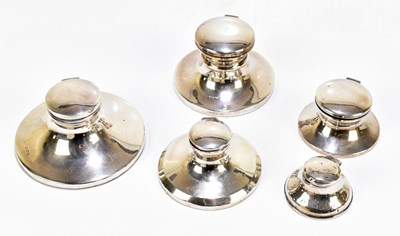 Lot 1079 - A collection of five hallmarked silver Capstan inkwells