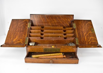 Lot 187 - An early 20th century oak letter rack and desk...