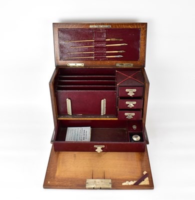 Lot 190 - An early 20th century oak desktop stationery...