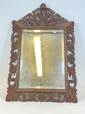 Lot 506 - A French oak acanthus bevelled mirror, height...