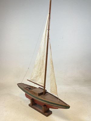 Lot 62 - A vintage wooden pond yacht with linen sails,...