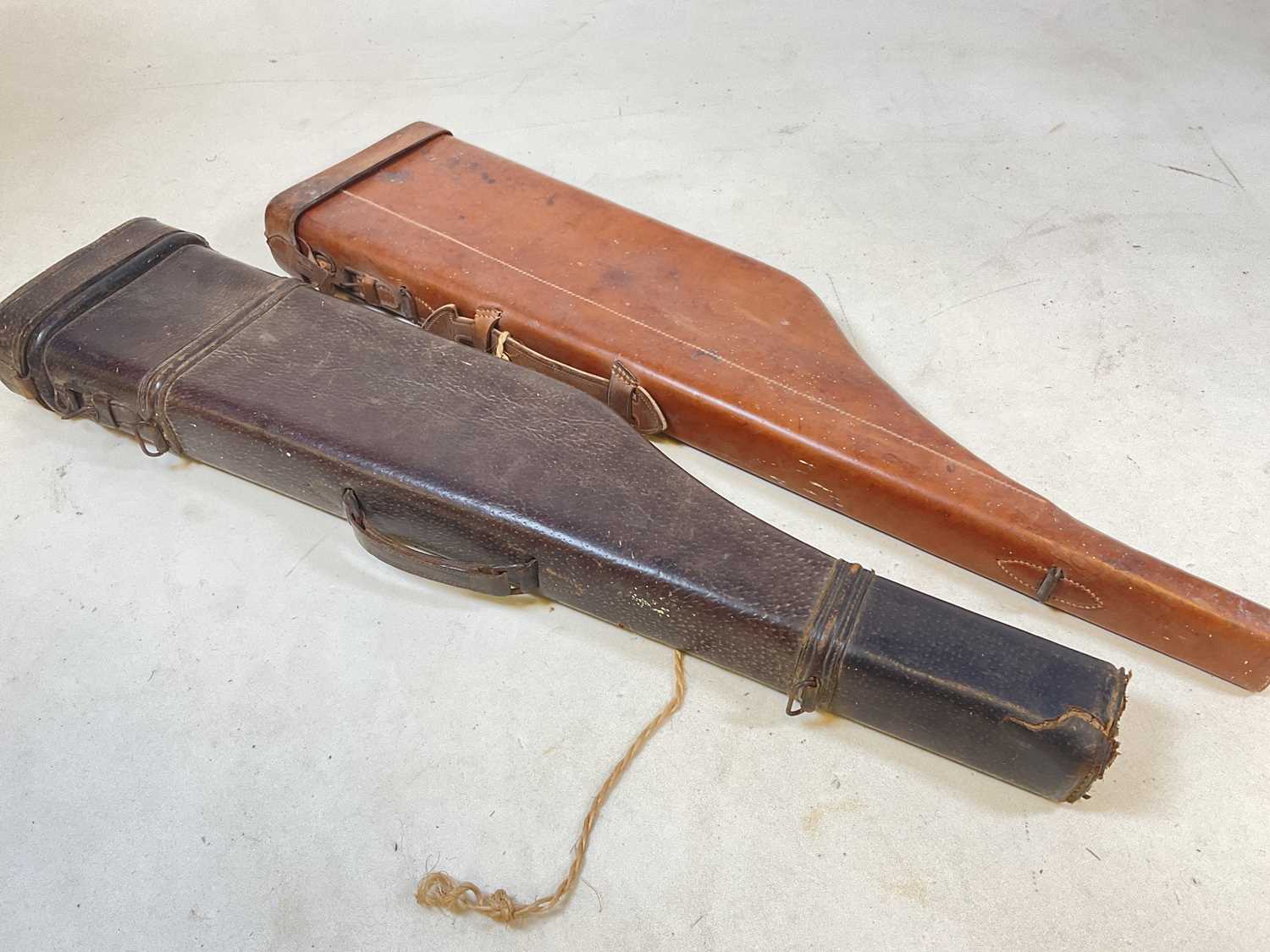 Lot 66 - Two vintage moulded leather leg of mutton gun...