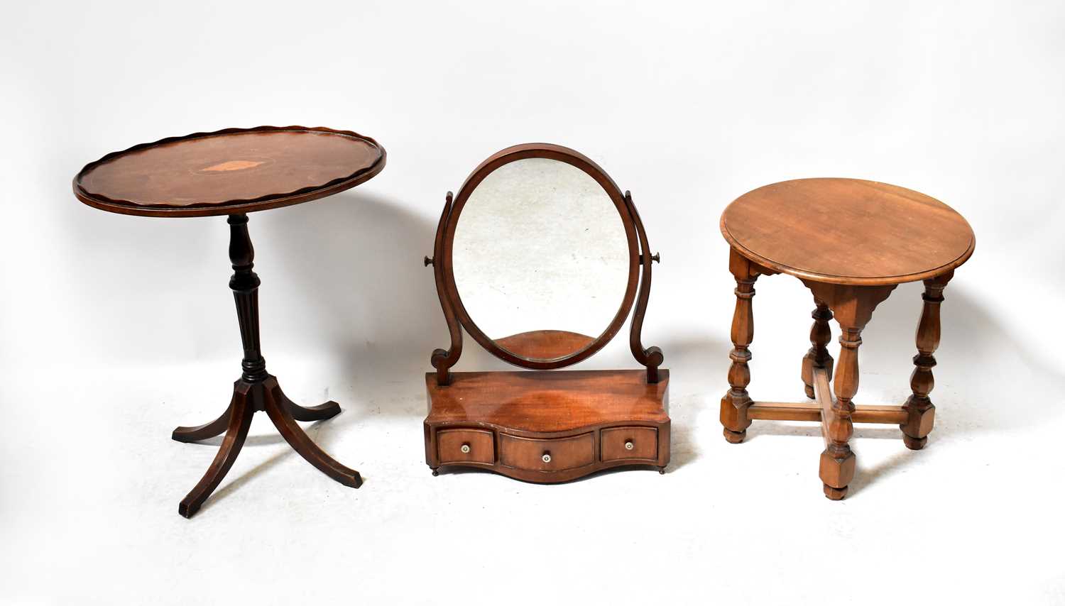 Lot 105 - A mahogany oval swivel toilet mirror on...