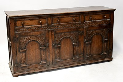 Lot 31 - An oak reproduction sideboard, three single...