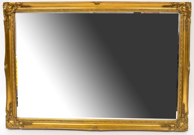 Lot 117 - A modern rectangular bevel edged wall mirror...