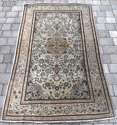 Lot 125 - A 20th century Eastern rug with centred floral...