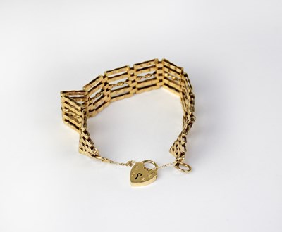 Lot 1161 - A 9ct yellow gold five bar gate bracelet with...