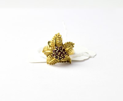 Lot 1005 - An 18ct yellow gold floral design ring, the...