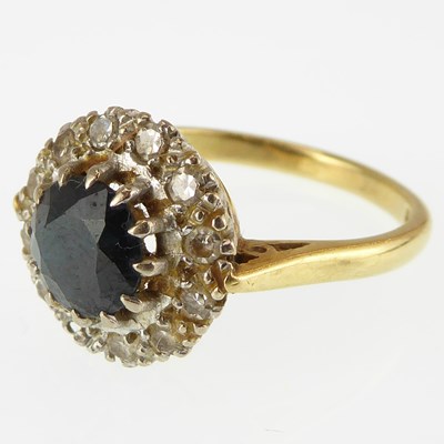 Lot 1085 - An 18ct gold ring set with central claw set...