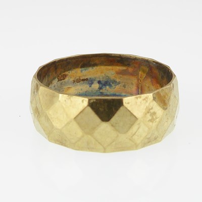 Lot 1098 - A 1970s 9ct gold wedding band with facet...