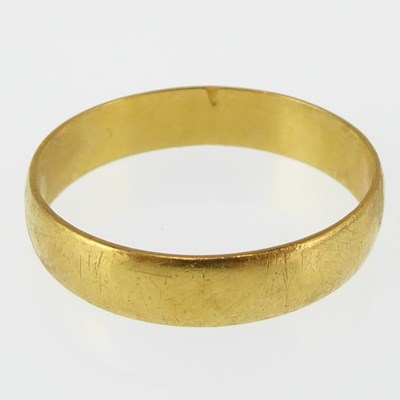 Lot 1020 - A 22ct gold band ring, size W, approx. 4.2g.