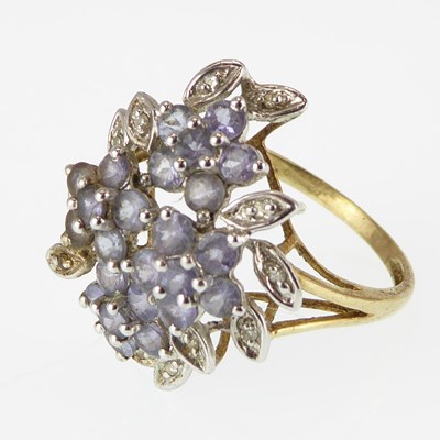 Lot 1129 - A 9ct gold ring set with four amethyst flower...