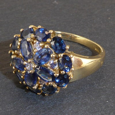 Lot 1070 - A 9ct gold dress ring set with blue stone...
