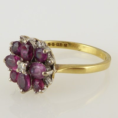 Lot 1060 - An 18ct gold ruby and diamond flower head...