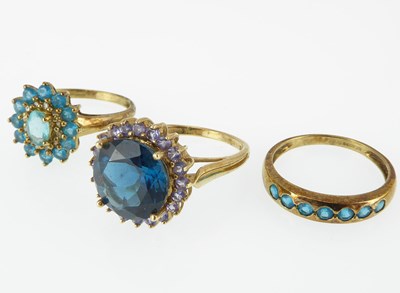 Lot 1063 - Three 9ct gold dress rings, all set with blue...