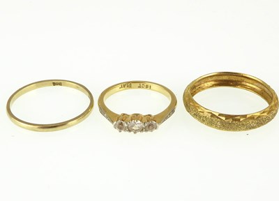 Lot 1065 - Three gold rings comprising an 18ct dress ring...