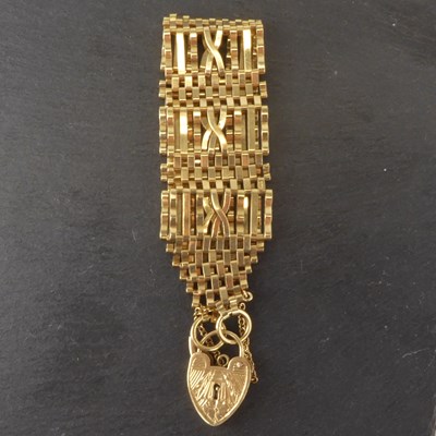 Lot 1159 - A 9ct gold eight bar gate bracelet, the centre...