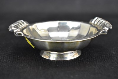 Lot 909 - A small silver twin-handled taster inscribed...