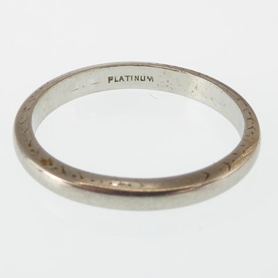Lot 1110 - A thin platinum wedding band, size M, approx....