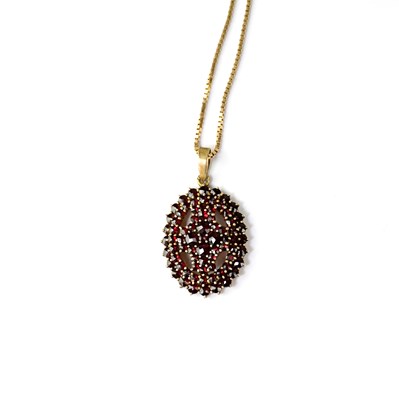Lot 1227 - A vintage garnet cluster pendant over three...