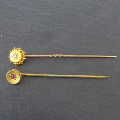 Lot 1287 - A 15ct gold pin with a circular star top and...