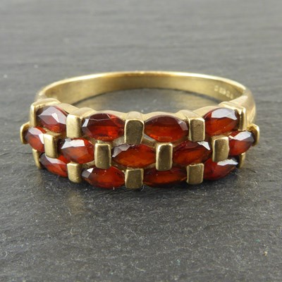 Lot 1141 - A ladies' 9ct gold garnet ring set with three...