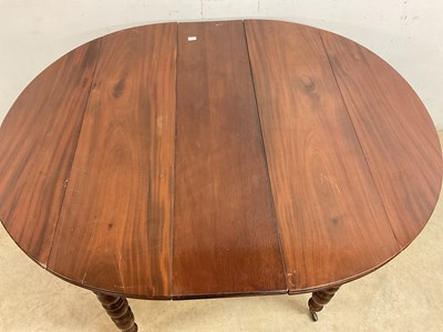 Lot 509 - A French mahogany pull-out dining table on...