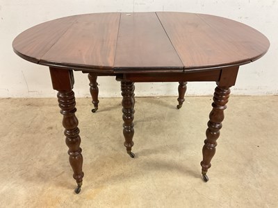 Lot 509 - A French mahogany pull-out dining table on...