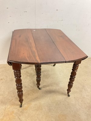 Lot 509 - A French mahogany pull-out dining table on...