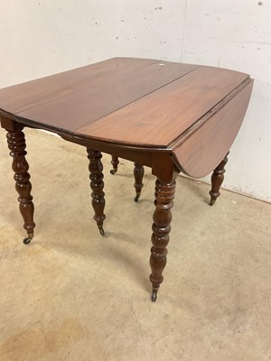 Lot 509 - A French mahogany pull-out dining table on...