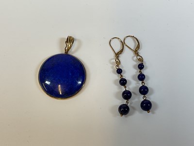 Lot 339 - A lapis lazuli pendant set in 9ct gold and a...