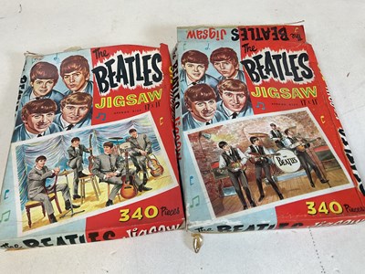 Lot 12 - Two boxed Beatles jigsaws (pieces not checked),...