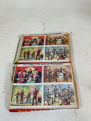 Lot 12 - Two boxed Beatles jigsaws (pieces not checked),...