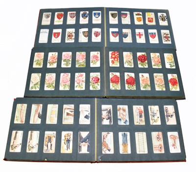 Lot 697 - Three cigarette card albums containing a selection of cigarette and tea cards