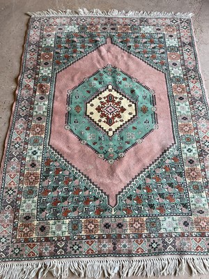 Lot 459 - A Moroccan pink ground rug with decorative...