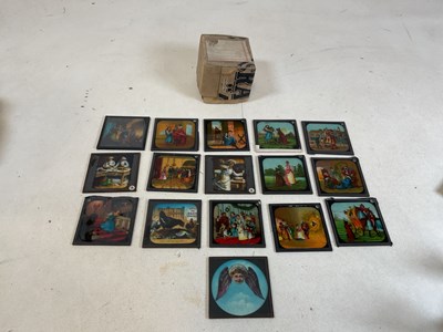 Lot 26 - A box of magic lantern slides featuring some...