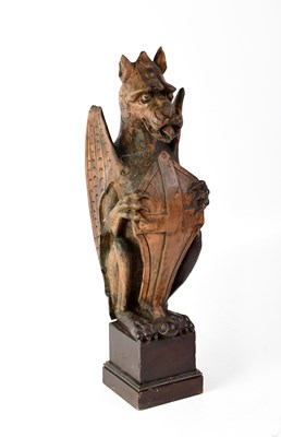 Lot 166 - A wooden carved mythical winged dragon holding...