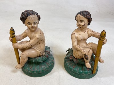 Lot 225 - A pair of painted cast iron statues on wooden...