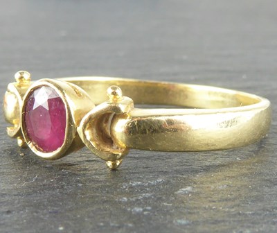 Lot 1120 - A 14ct gold ring with oval bezel set ruby,...