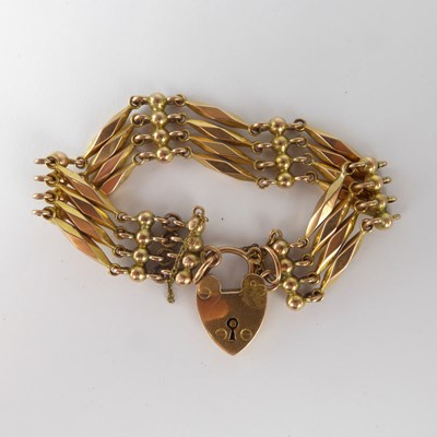 Lot 1163 - A 9ct gold four bar gate bracelet, the ball...