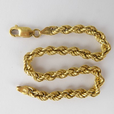Lot 1147 - An 18ct gold rope twist bracelet, length 20cm,...