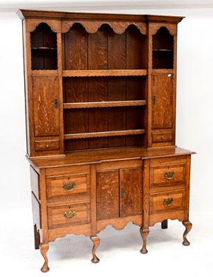 Lot 28 - A George III style oak dresser with enclosed...