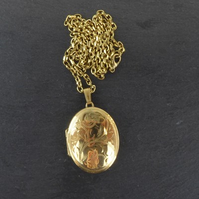 Lot 1230 - A 9ct gold oval double locket with floral...