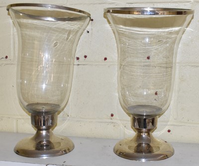 Lot 506 - A pair of large glass storm lamps on plated...