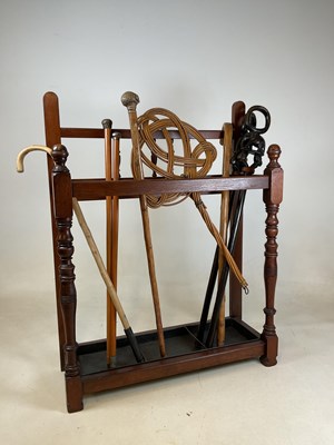 Lot 476 - A mahogany stick stand with three compartments...