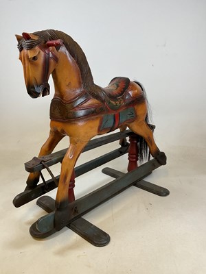 Lot 486 - A small carved and painted rocking horse on a...