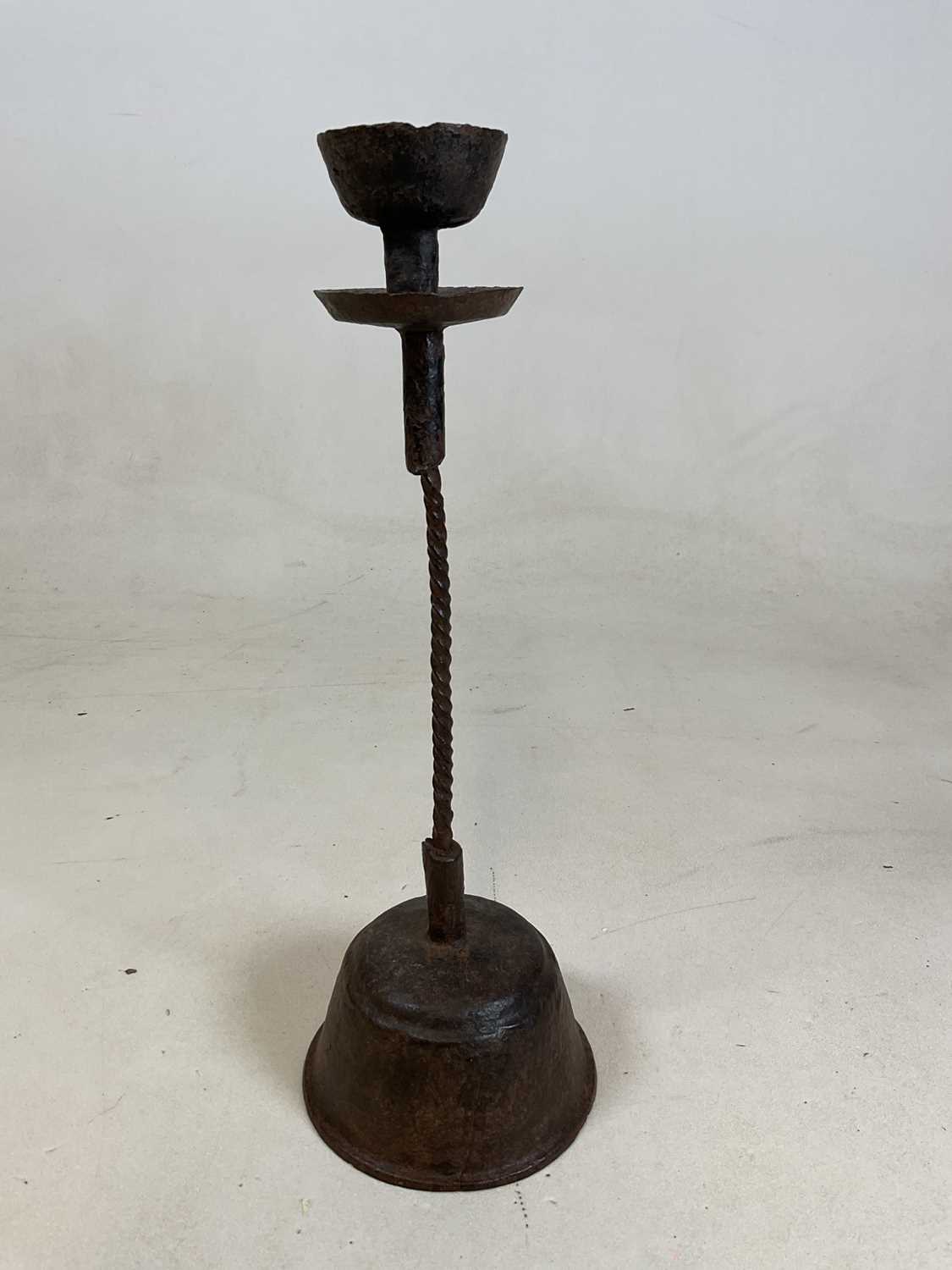 Lot 201 - A late 16th century wrought iron candlestick,