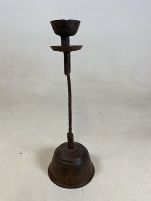 Lot 201 - A late 16th century wrought iron candlestick,...