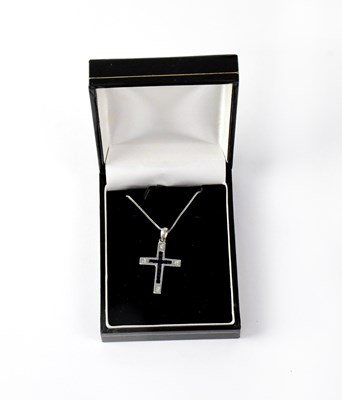 Lot 1220 - A 9ct white gold cross set with sapphires and...