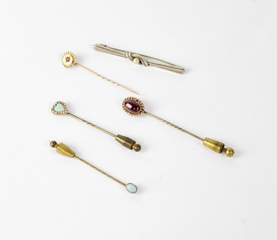 Lot 1211 - Four yellow metal stick pins, one with...
